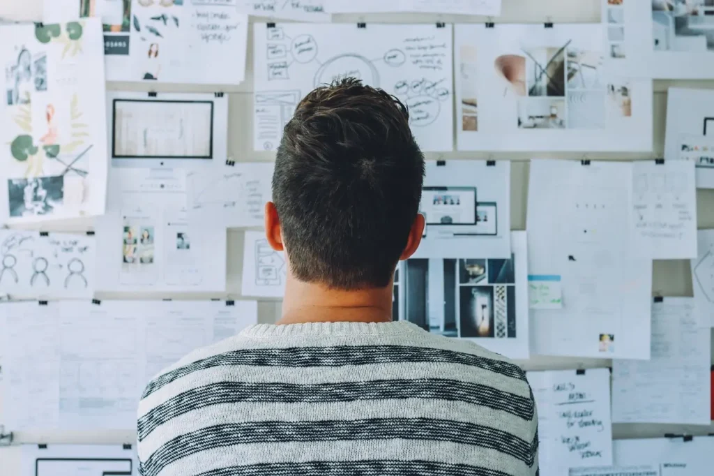 Man staring at task board