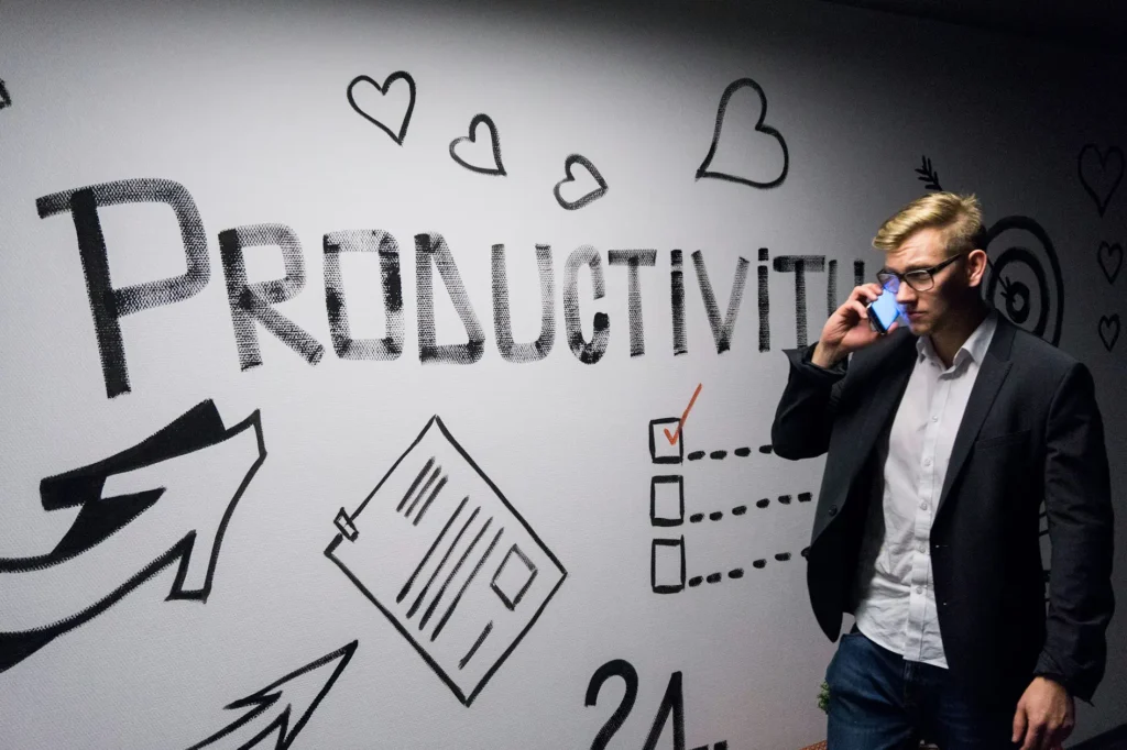 Man standing by productivity sign