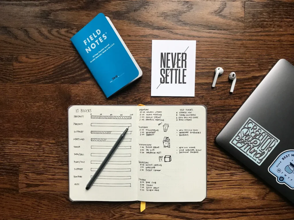 Desk filled with books and a laptop